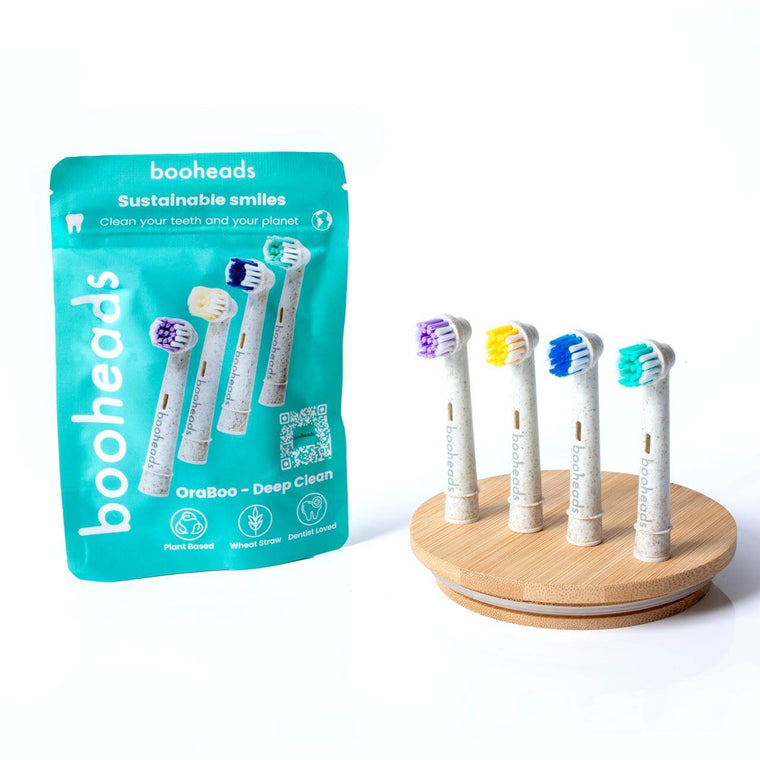 booheads Oraboo wheat straw electric toothbrush heads compatible with OralB*, 4 pack with resealable pouch on a bamboo stand