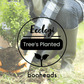 Person holding a potted plant with 'Ecologi' and 'booheads' branding overlay.