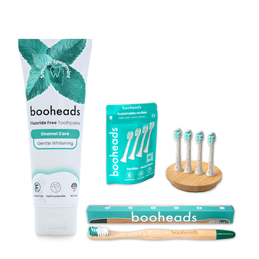 booheads dental product set including toothpaste, toothbrushes, and packaging on a white background