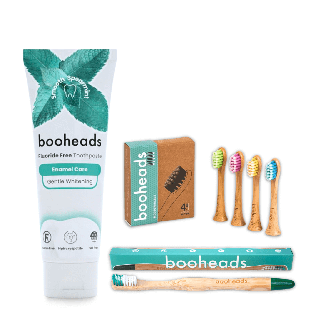 booheads dental care products including toothpaste, toothbrushes, and packaging on a white background