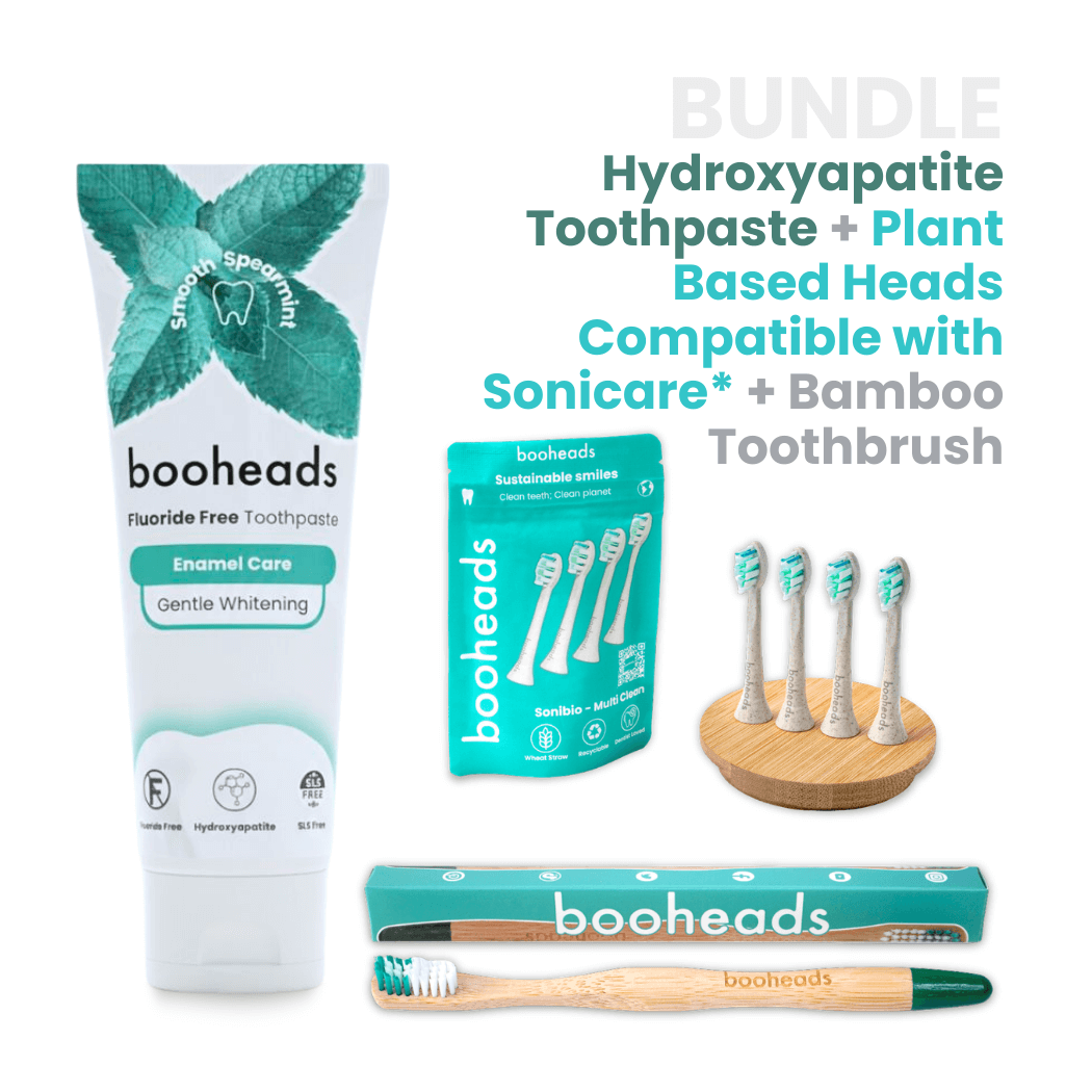booheads toothpaste, toothbrush heads, and bamboo toothbrush on a white background