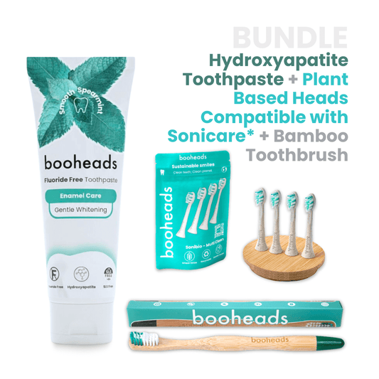 booheads toothpaste, toothbrush heads, and bamboo toothbrush on a white background