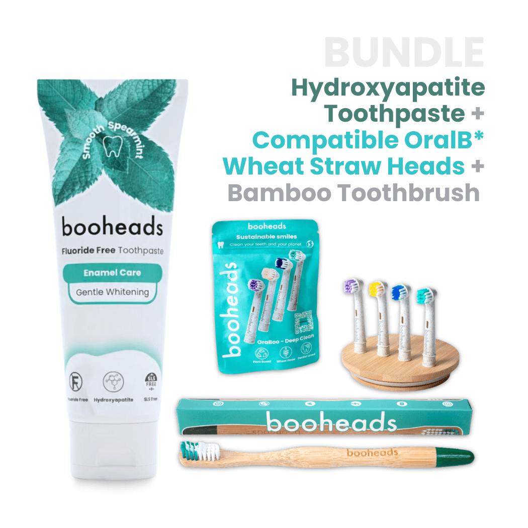 booheads toothpaste, OralB*-compatible heads, and bamboo toothbrush on a white background