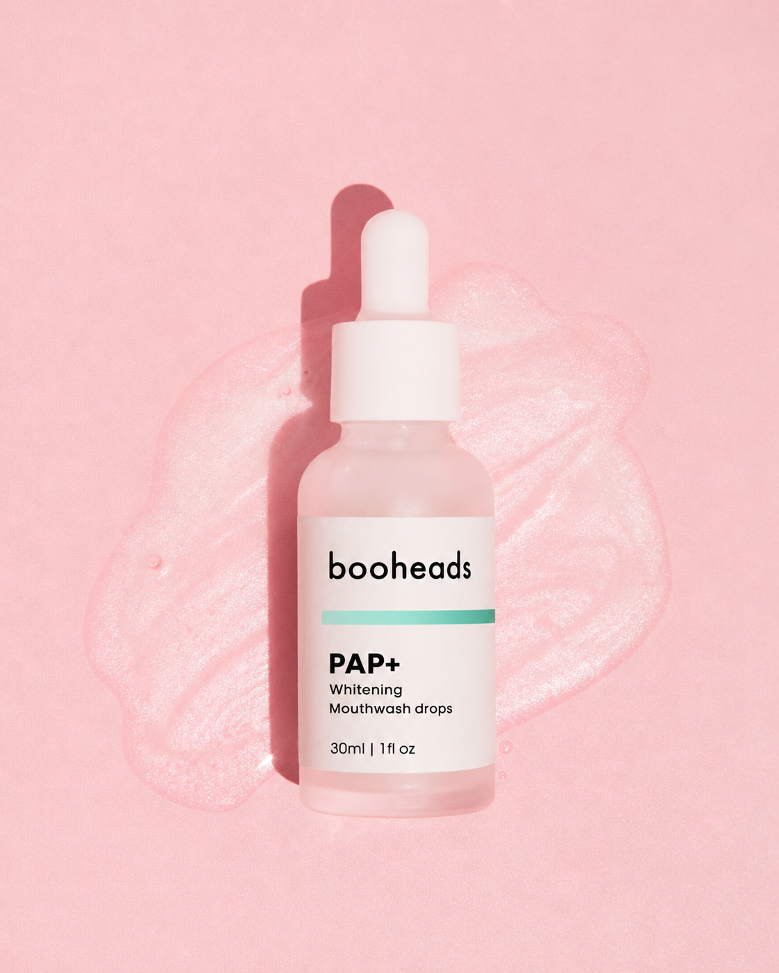 booheads PAP+ Whitening Mouthwash Drops 30ml glass dropper bottle on a pink background