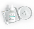 booheads PAP+ Whitening Mouthwash Drops bottle beside a dish of clear whitening serum