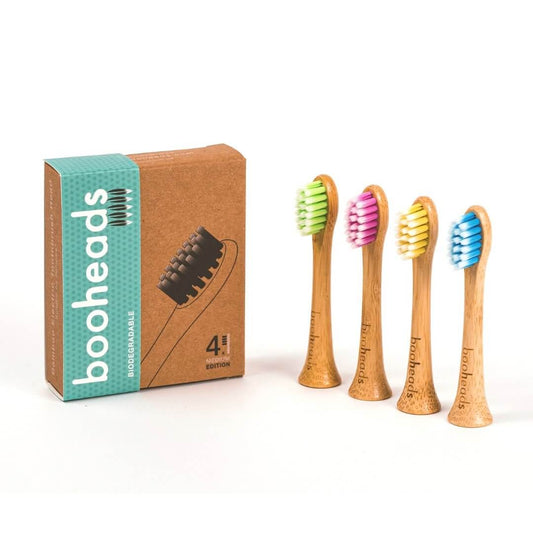 Set of bamboo toothbrushes with colorful bristles and packaging on a white background