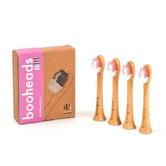 Set of wooden toothbrushes with packaging on a white background