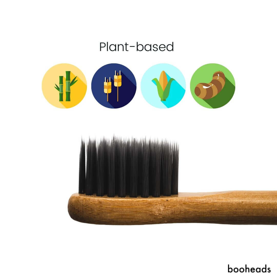 Close-up of black charcoal bristles on a booheads bamboo toothbrush head with plant-based material icons